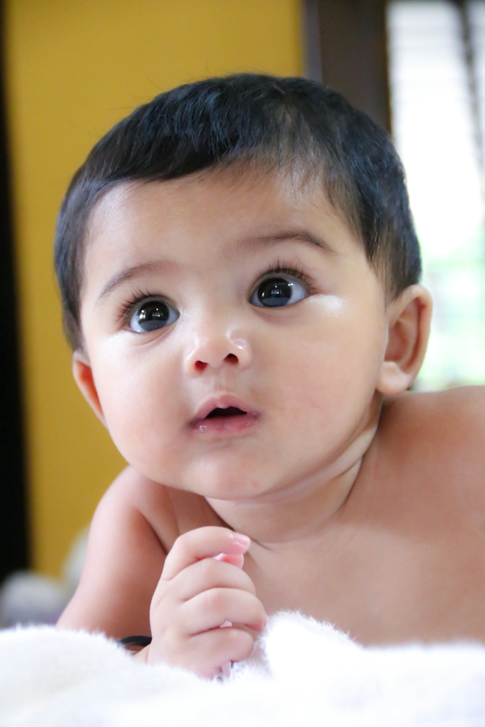 Baby with wide eyes looking upward